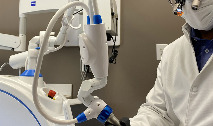 Signature Smiles | Dentist using advanced dental equipment for patient care
