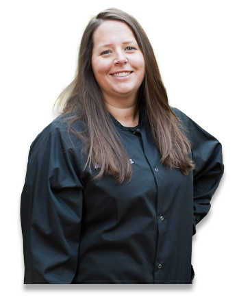 Signature Smiles | Hover Dental team member smiling outdoors wearing black uniform jacket